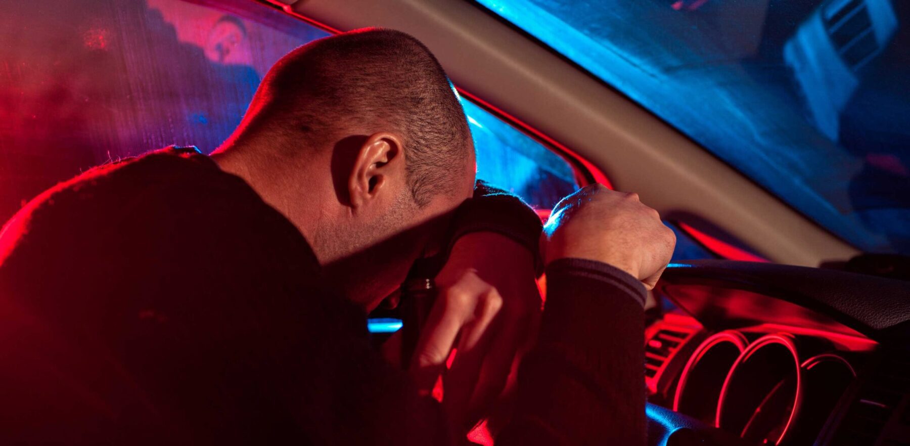 Man pulled over for driving under the influence with police flashers in his window