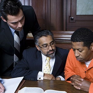 Criminal defense lawyer and their client looking over documents